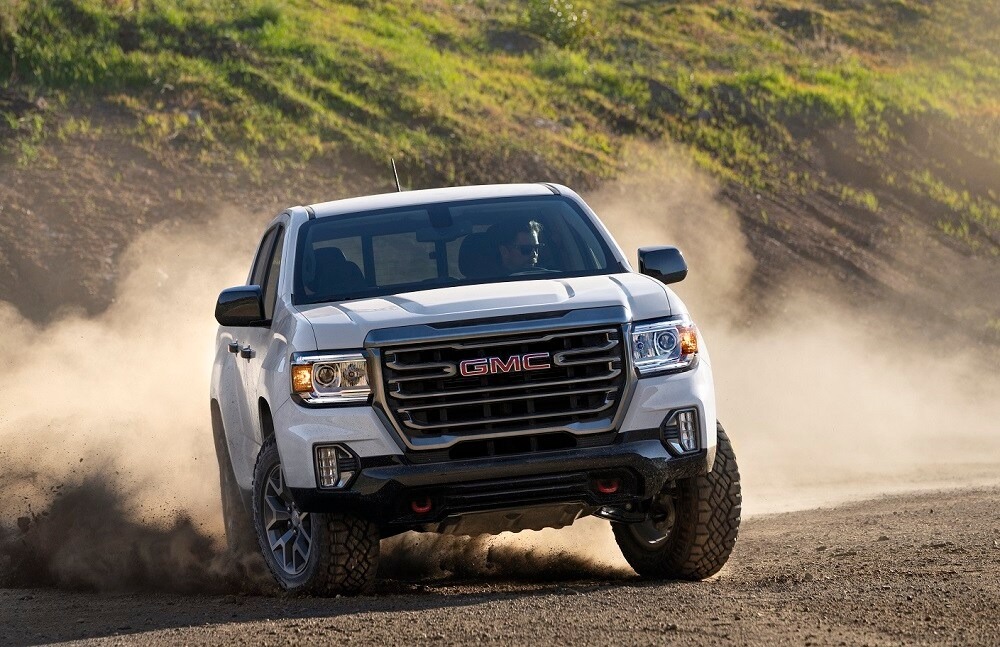 GMC truck kicking up dust while driving