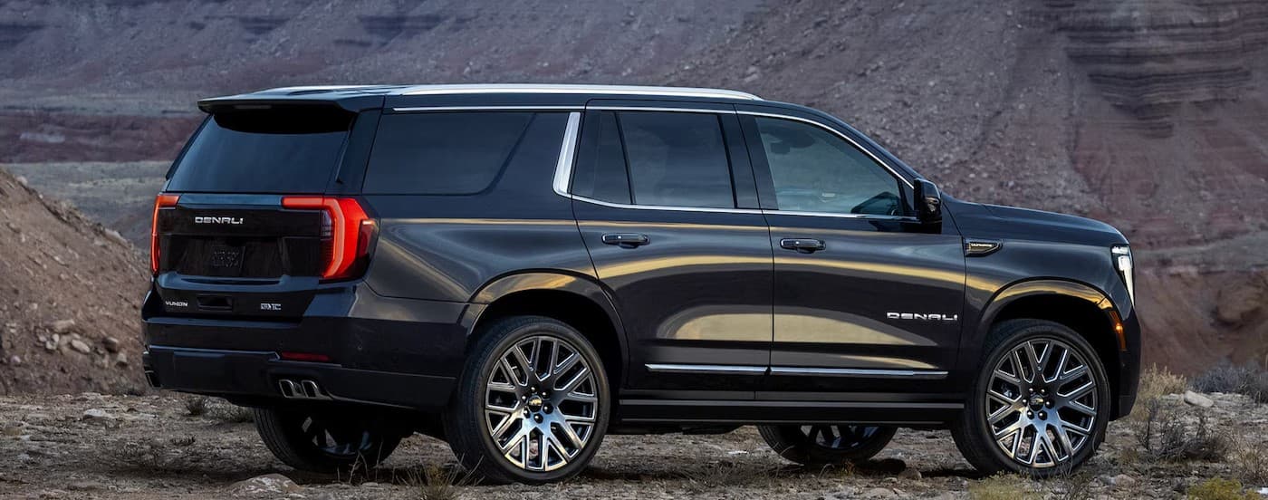 A black 2025 GMC Yukon Denali parked off-road after visiting a GMC dealer near Olathe.