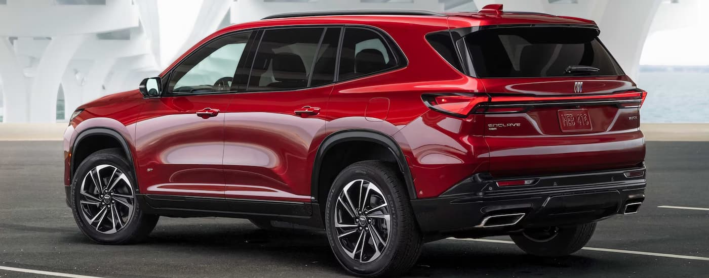A red 2025 Buick Enclave parked under an overpass